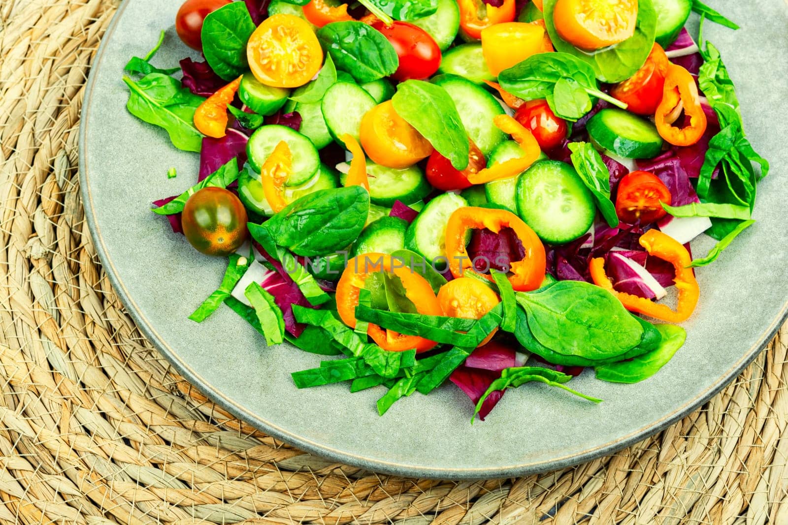 Spring salad of tomatoes, cucumbers, peppers and lettuce.