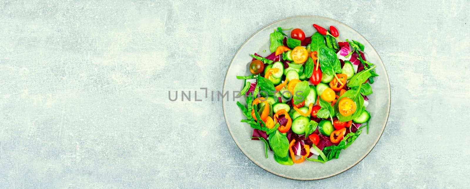 Spring salad of tomatoes, cucumbers, peppers and lettuce.
