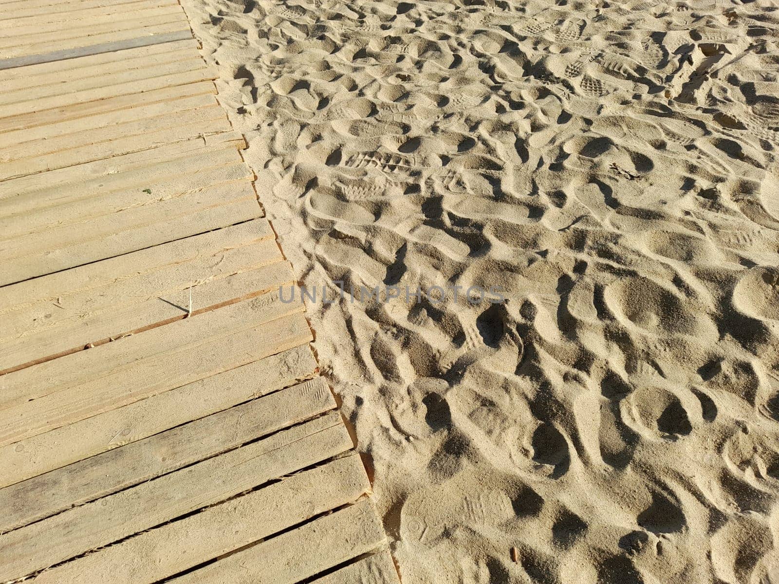 Wooden jetty on a sand beach