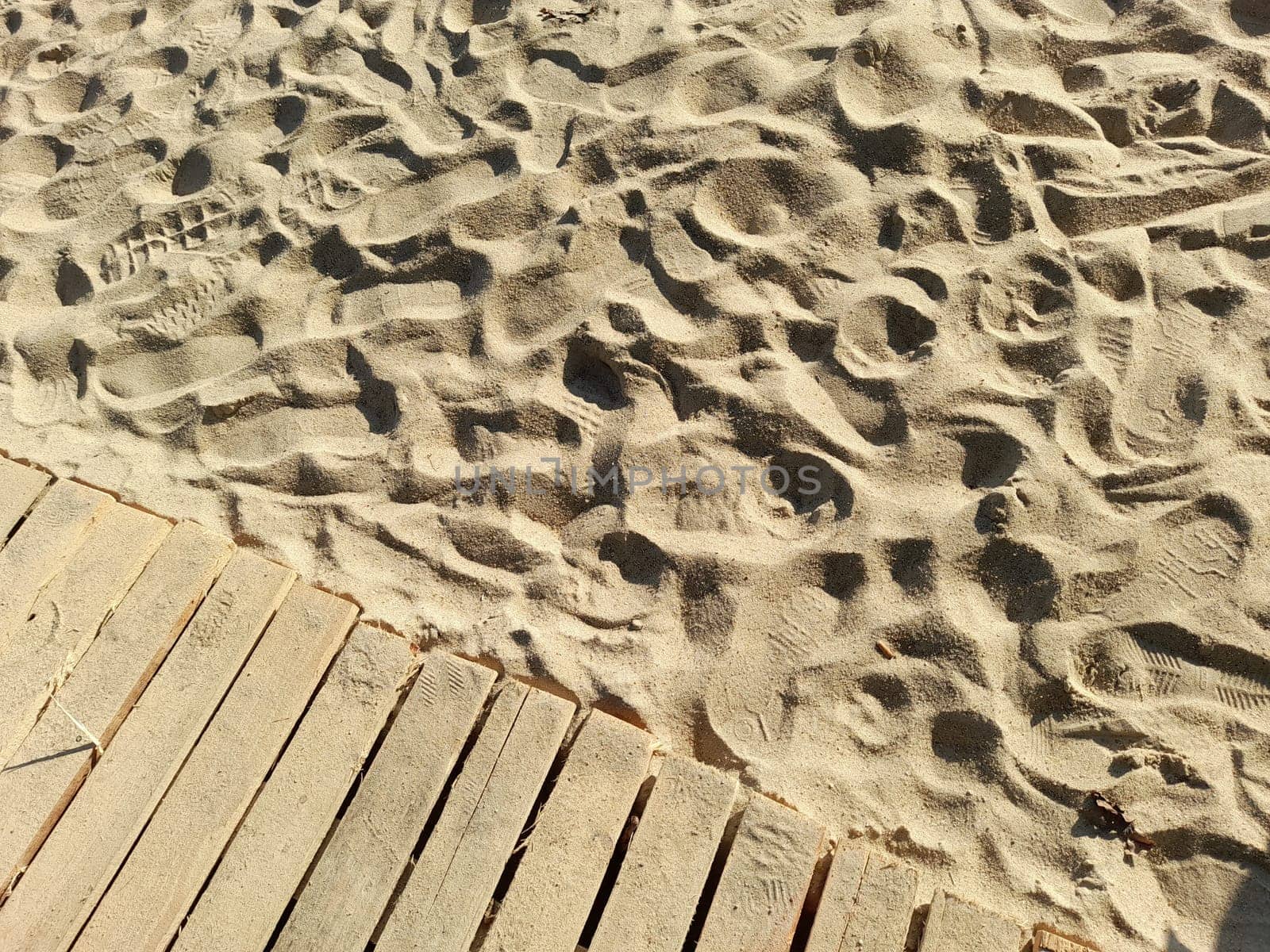 Wooden jetty on a sand beach