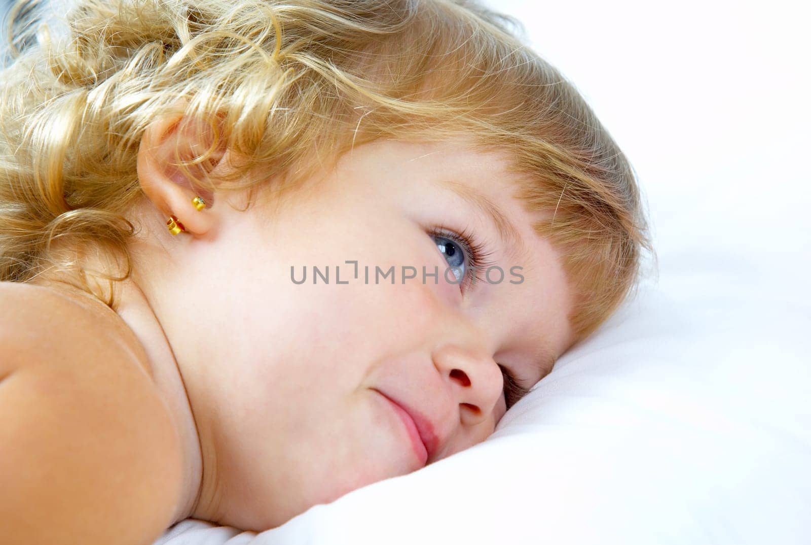 High key portrait of young blue eyed baby