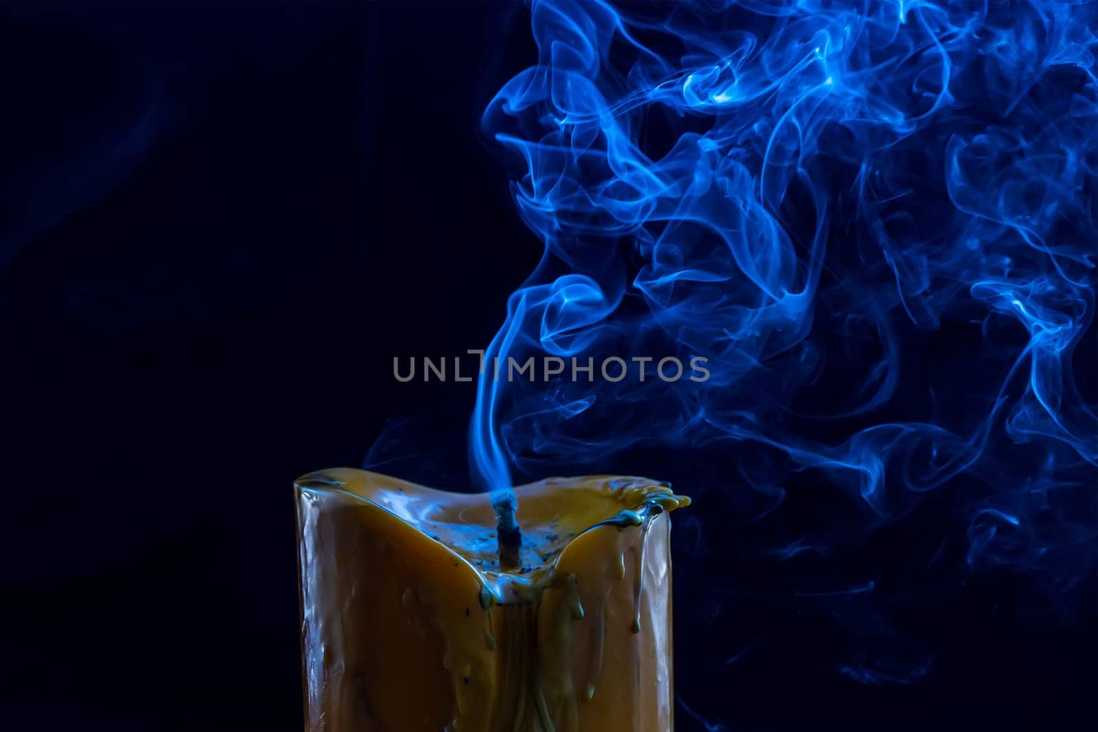 The big candle smoke is colorful. It is abstract.