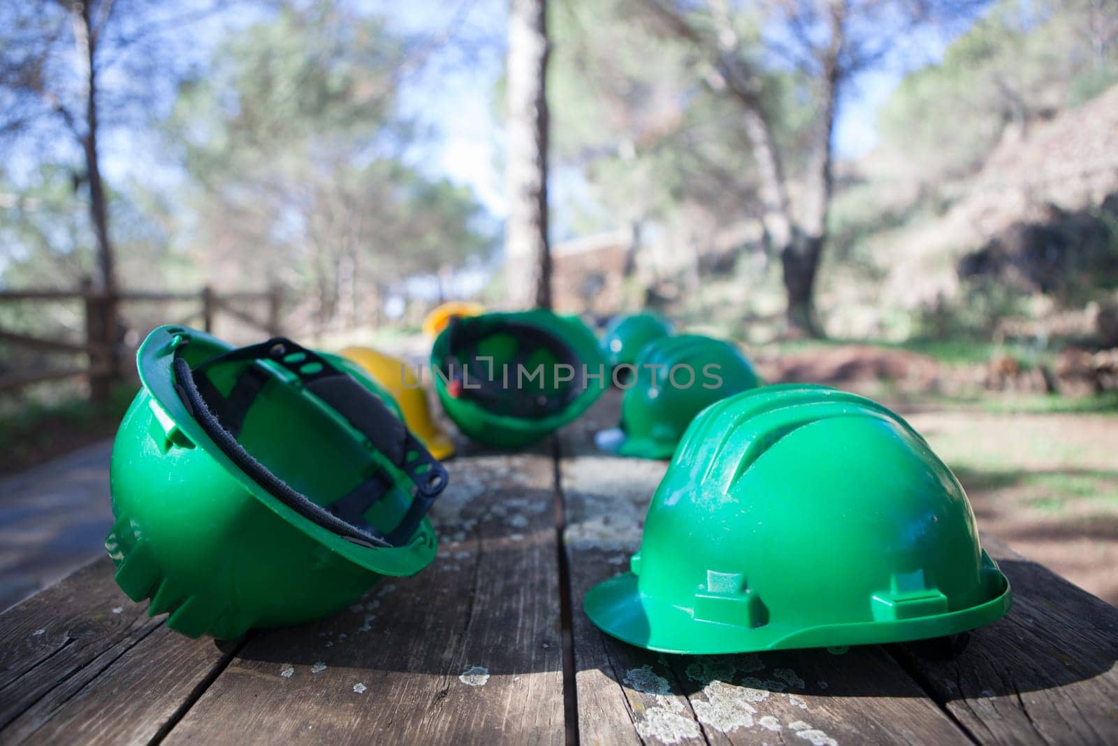 Mine The Jayona, declared natural monument. Fuente del Arco, Badajoz, Spain. Helmets over wooden table