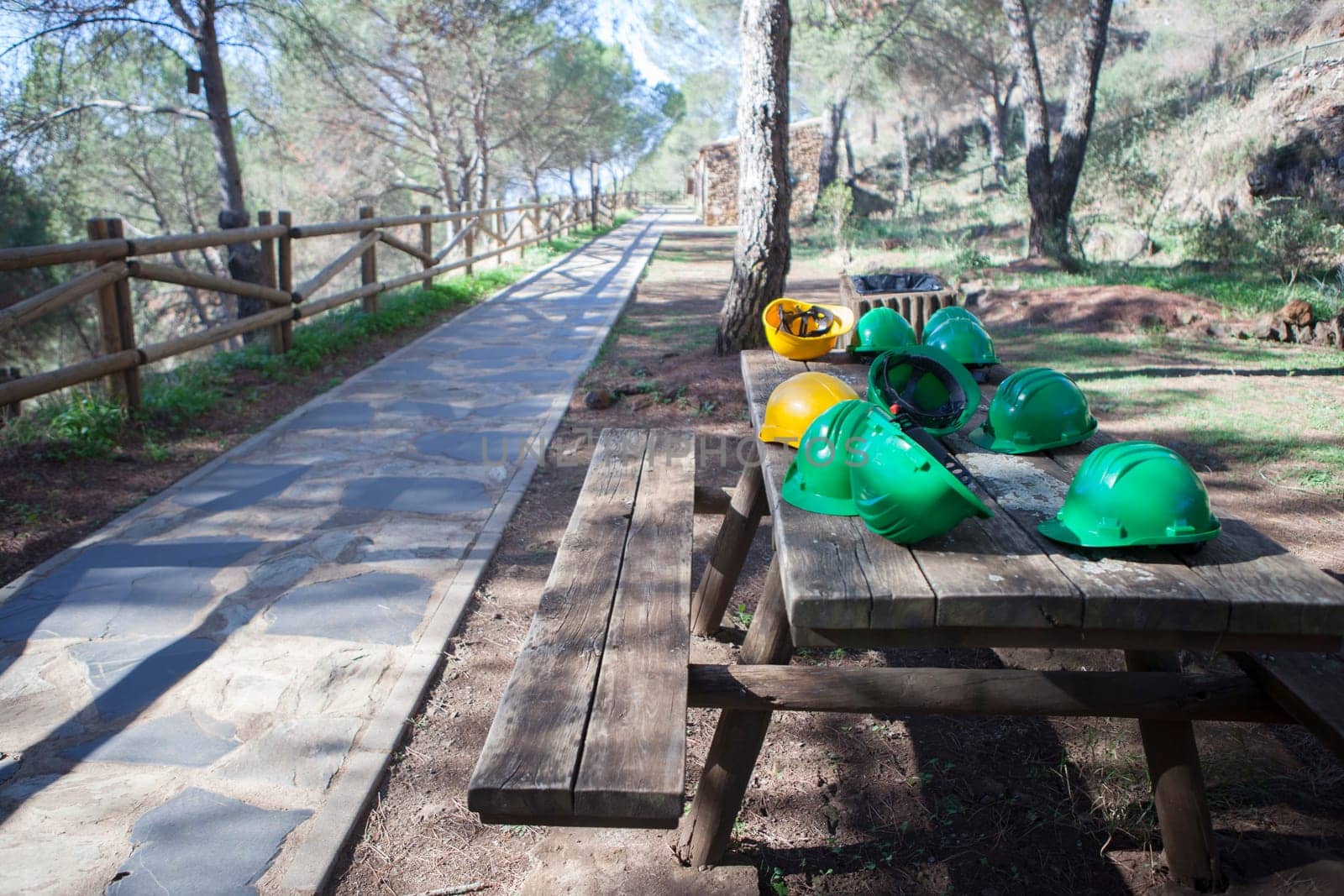 Mine The Jayona, declared natural monument. Fuente del Arco, Badajoz, Spain. Helmets over wooden table