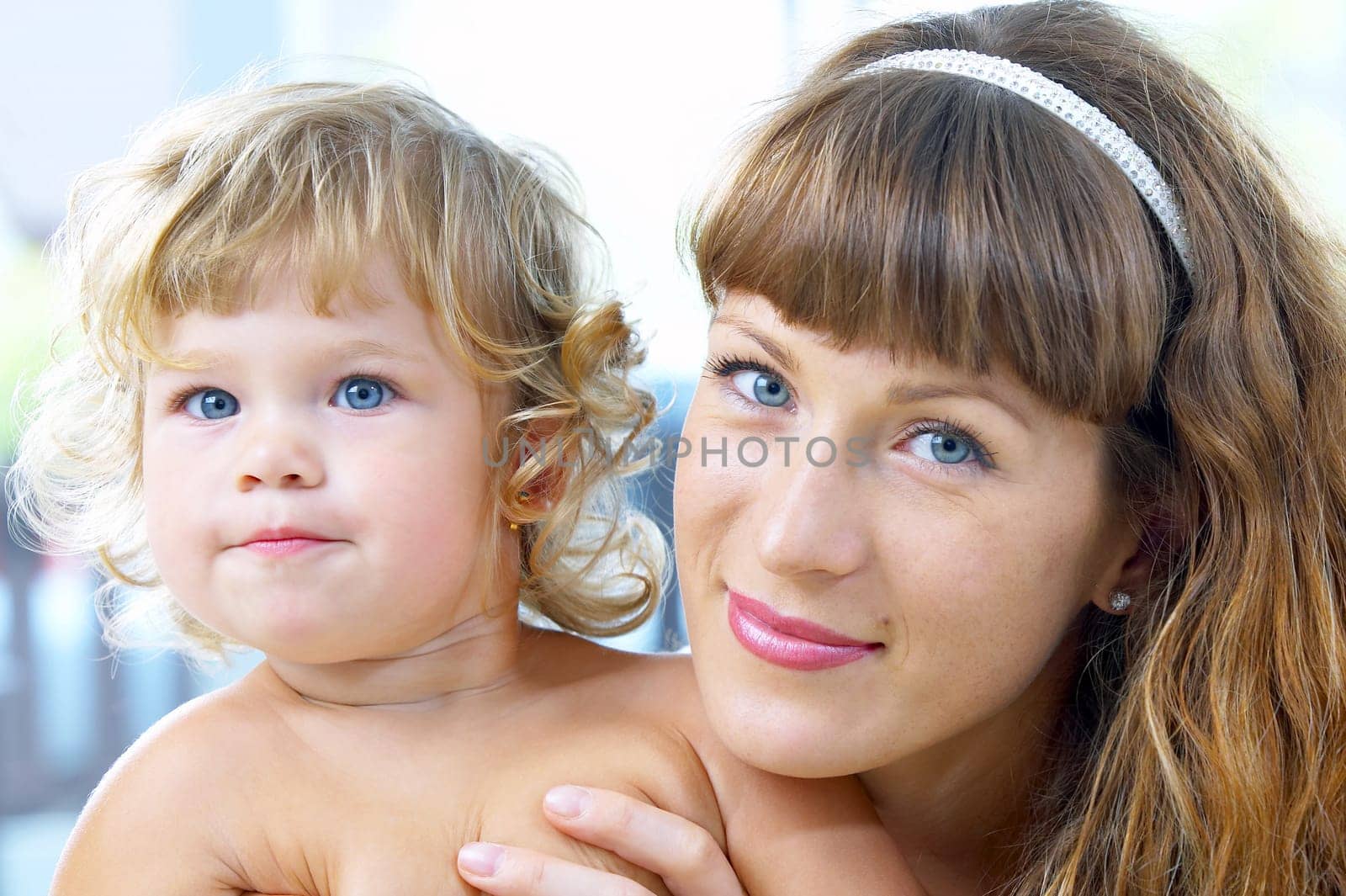 High key portrait of happy mother with baby