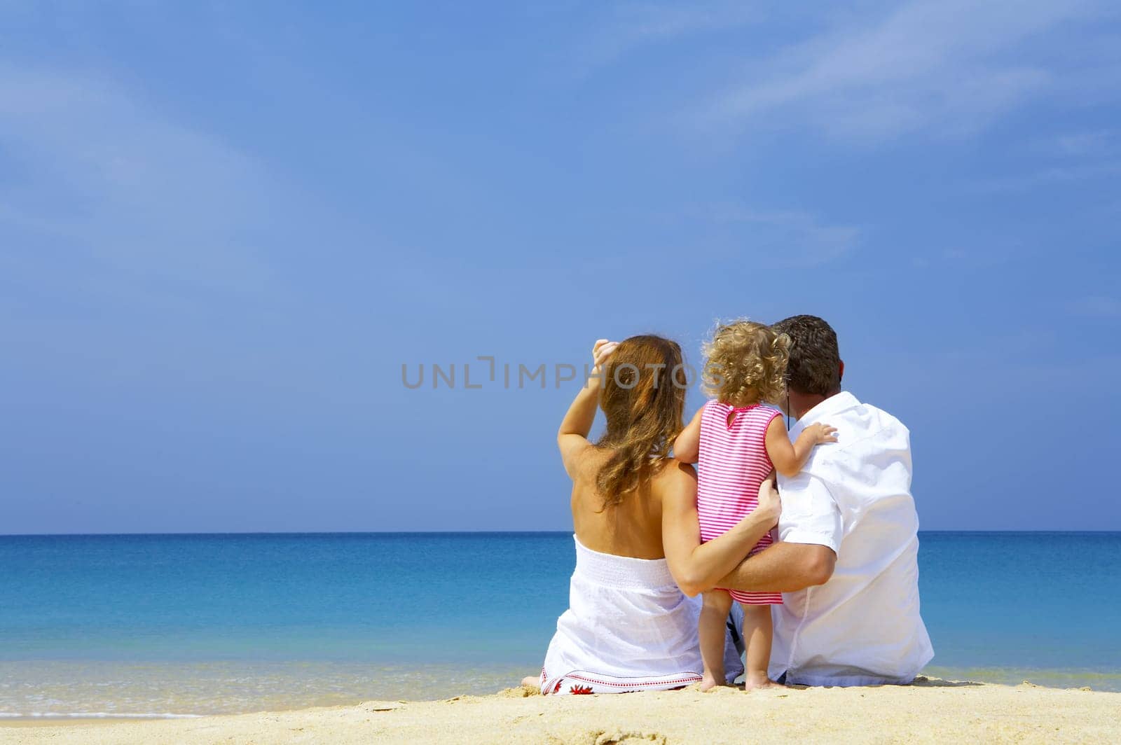 Portrait of young family having fun on the beach