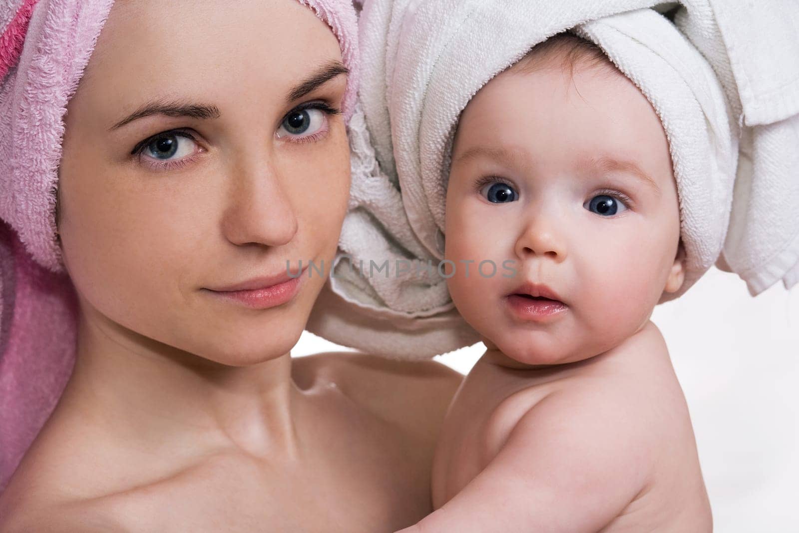 beautiful mother and daughter with a towel