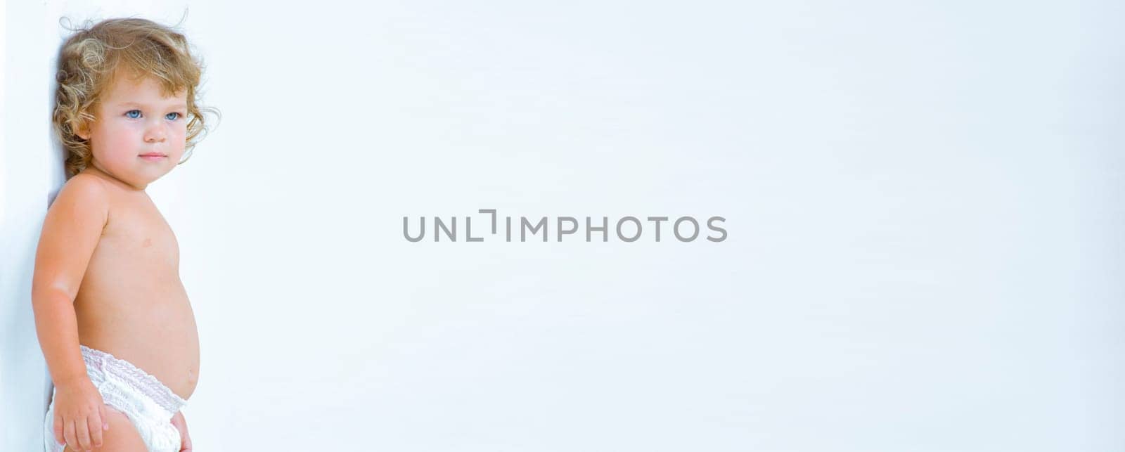 High key portrait of young blue eyed baby, banner, lots of copy space