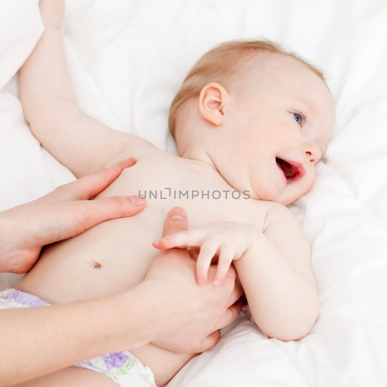Mother massaging her child, shallow focus