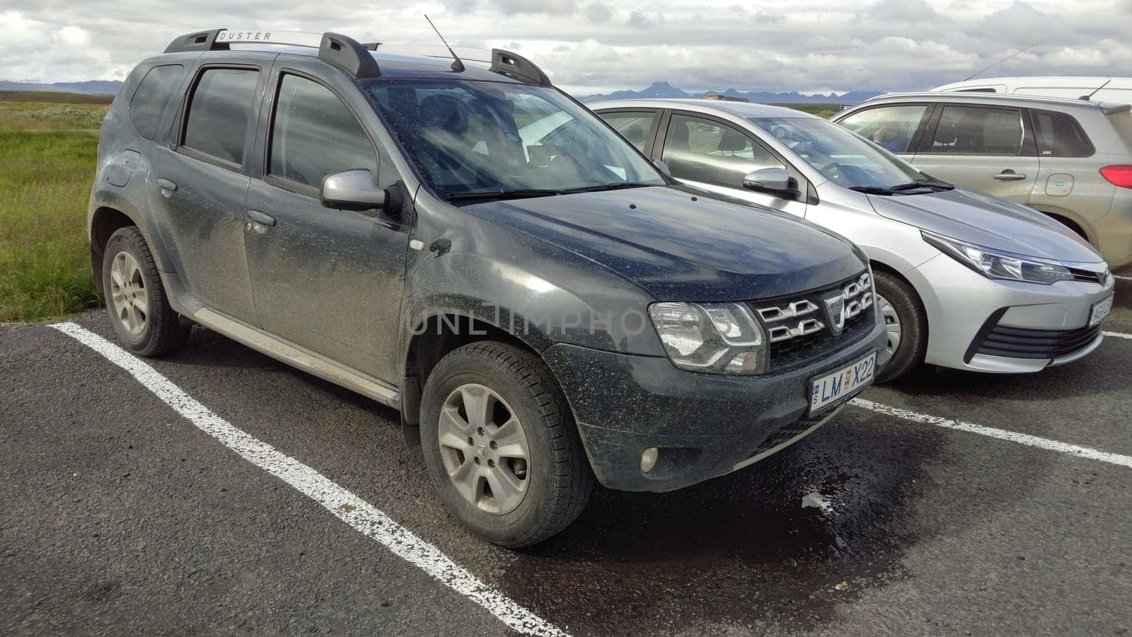 Dirty Dacia Duster car parked outside after off-road ride in Iceland