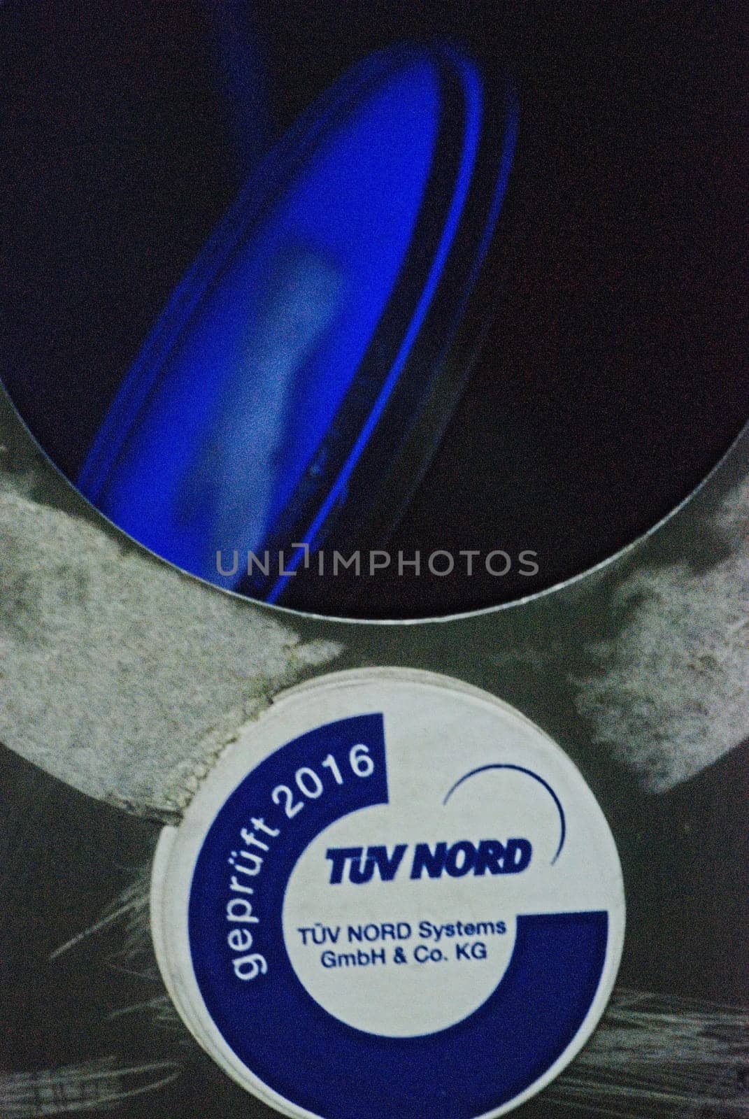 Vertical closeup of a broken escalator column with TUEV Nord test seal on the A40 in Essen, Germany