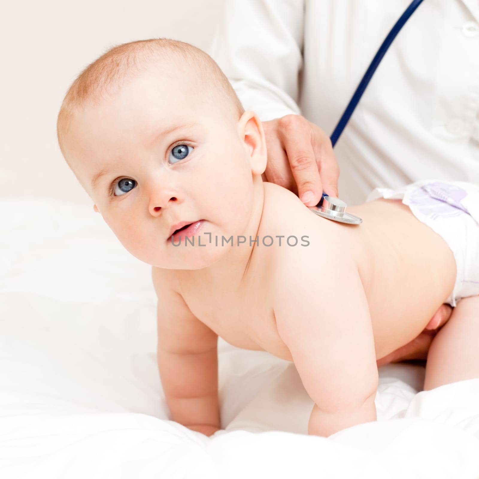 Children's doctor exams infant with stethoscope