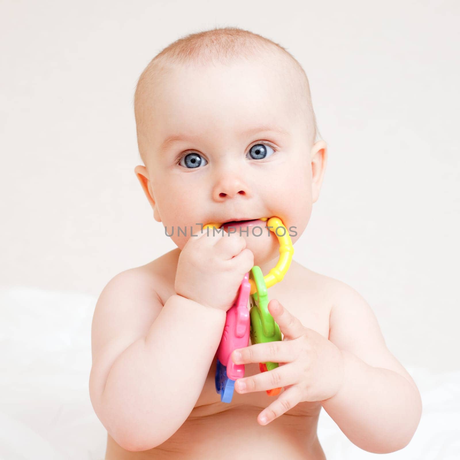 Little baby girl with teething toy