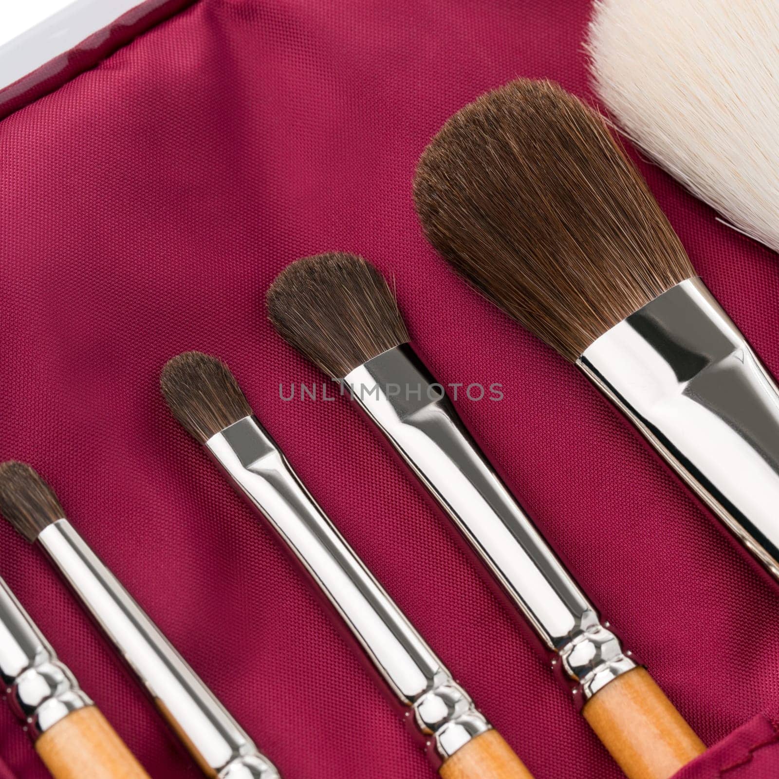 Various makeup brushes with soft bristles displayed in a vibrant case, ideal for professional or personal use during makeup application.