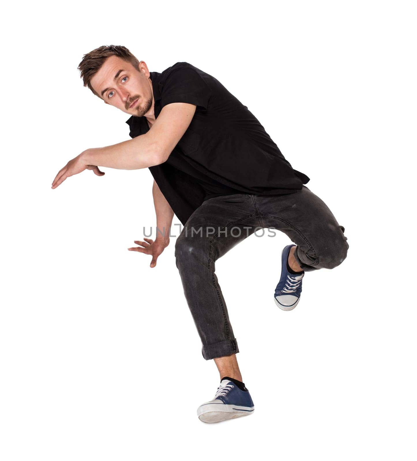 Break dancer doing an one handed handstand against a white background