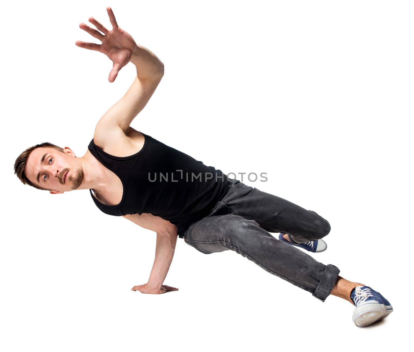 Break dancer doing an one handed handstand against a white background