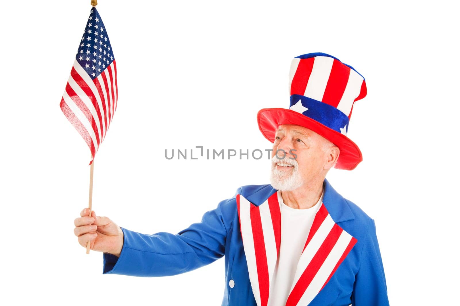 American icon Uncle Sam looks at a US Flag.  Isolated on white.
