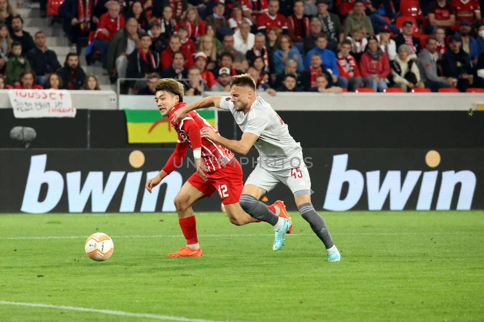 Ritsu Doan (SC Freiburg),goal-threatening and often only stopped by a foul,as here by Oleg Reabciuk (Olympiakos Piraeus / Greece) in the match of the football Europa League - Matchday 5,SC Freiburg vs. Olympiakos Piraeus