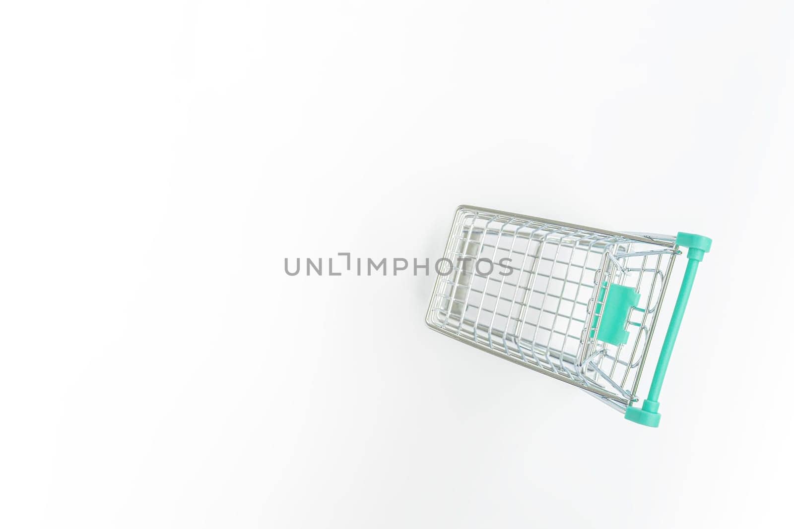 Empty shopping trolley on white background. Copy space.