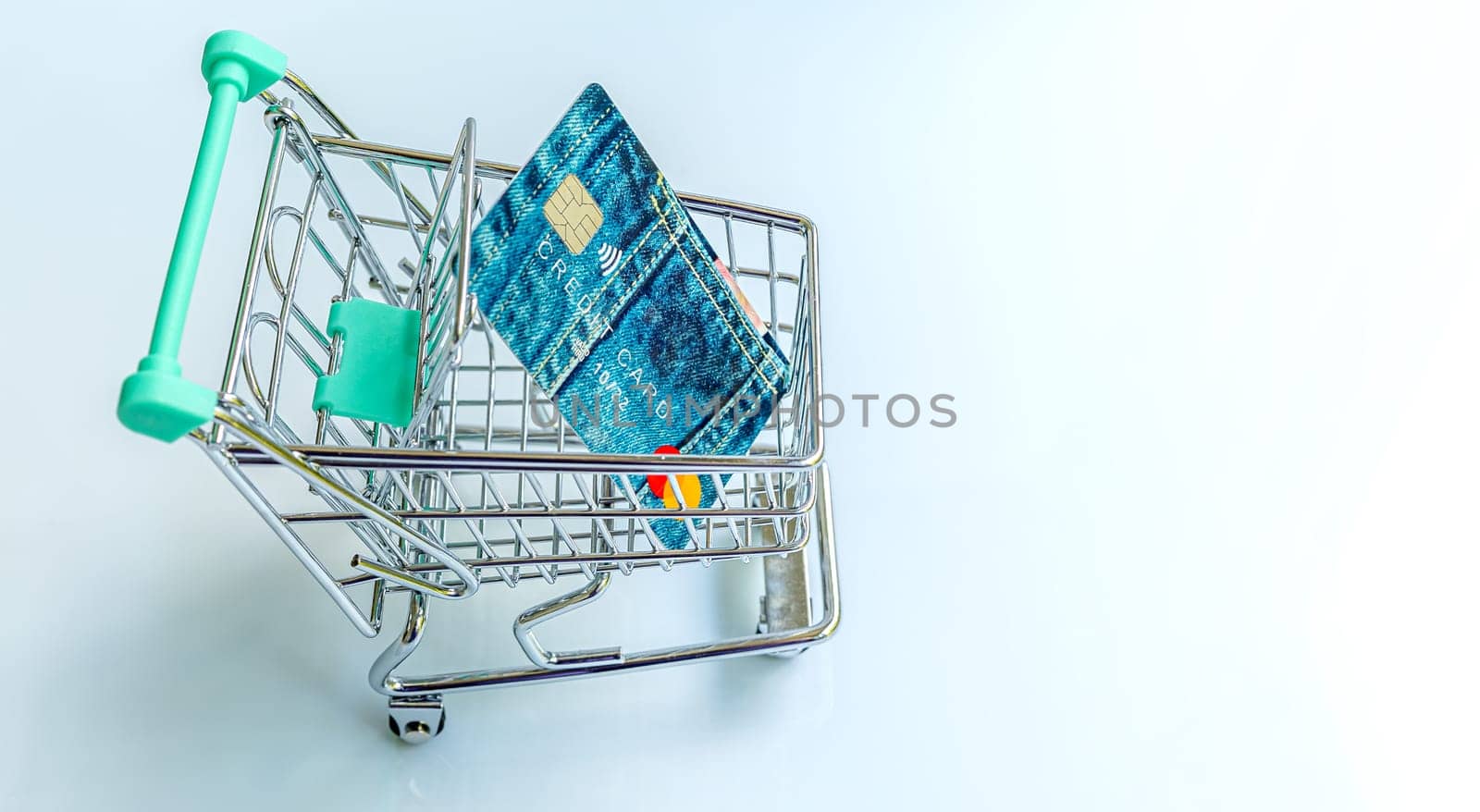 Shopping trolley with credit card on white background. On line shopping concept.