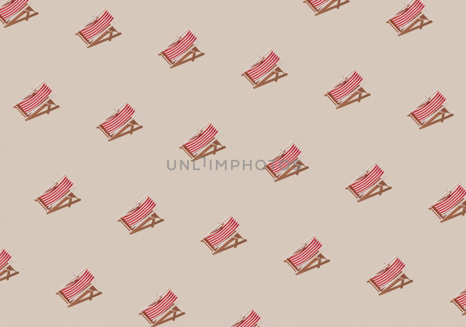 Vacation, beach, travel or relaxation concept. Beige background flat lay as symbol of sand with mini sun lounger for beach chair. Minimalism with copy space area for text, wooden red-white lounge