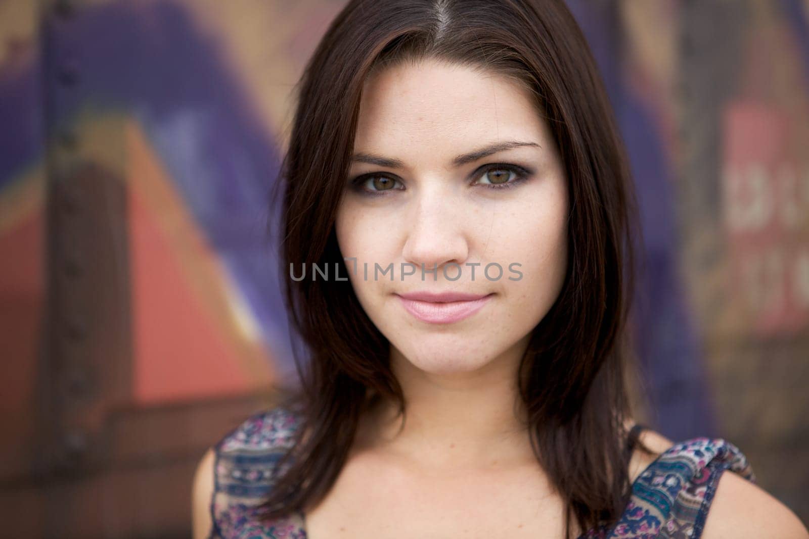 Beautiful Brunette with an edge and darker eye makeup looking at camera