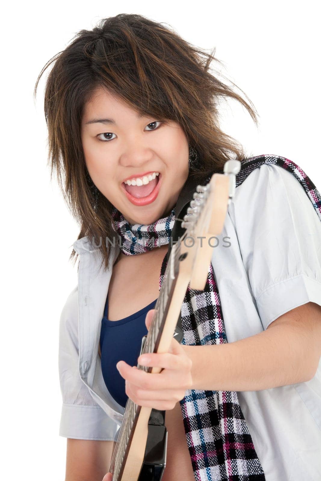 Caucasian teenager posing as a punk rocker on white background