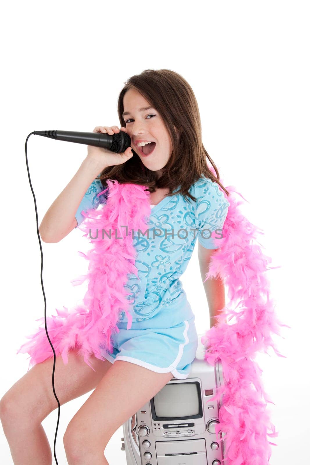 Caucasian children singing karaoke on a white background