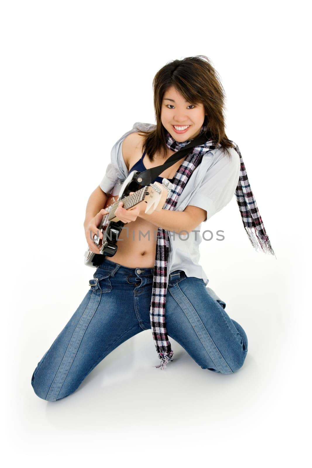 Caucasian teenager posing as a punk rocker on white background