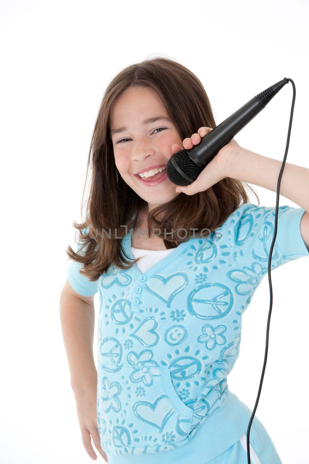 Caucasian children singing karaoke on a white background