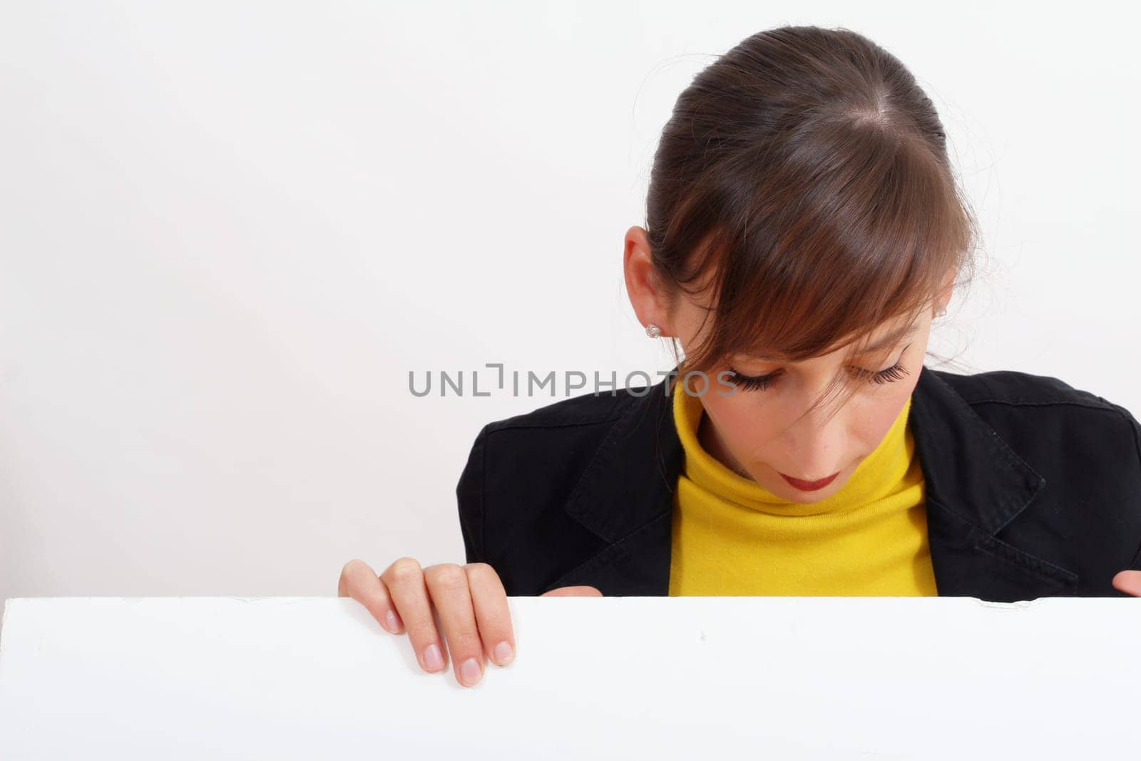 smiling woman with a blank bulletin board over white