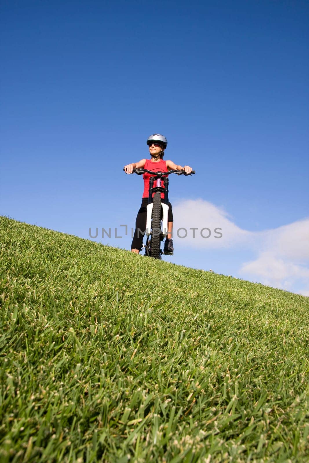 Women with mountain bicycle on the top of a hill