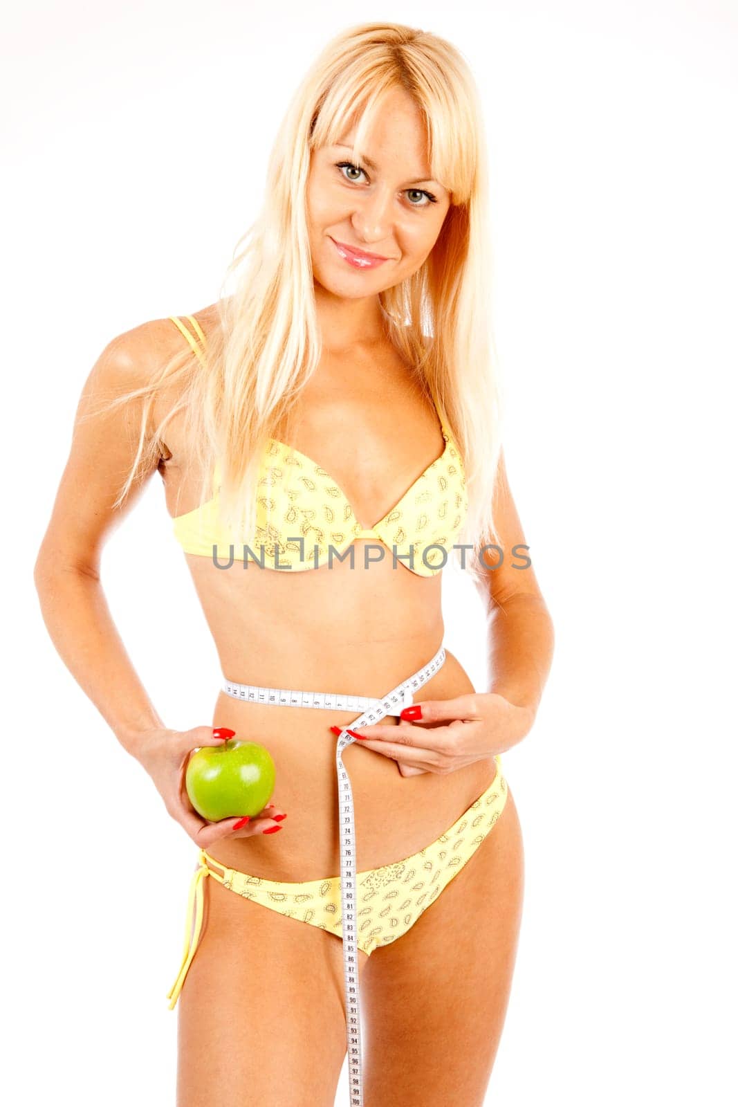 young pretty blond woman controls her waist
