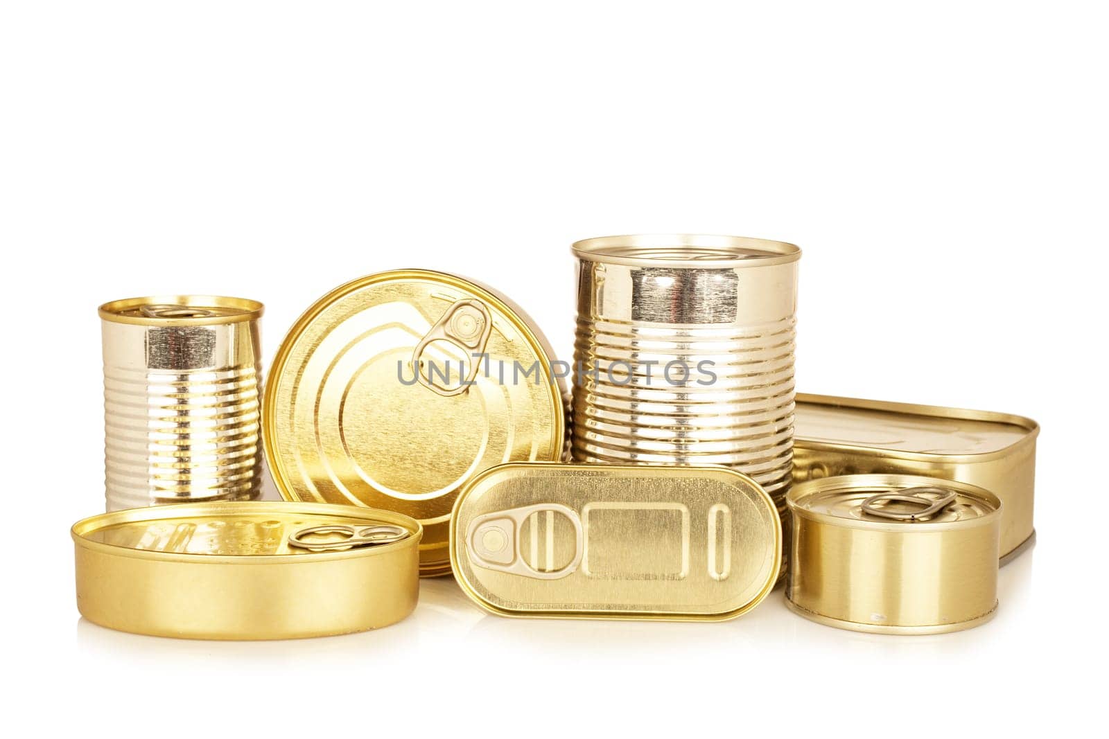 Assortment of golden food tin can reflected on white background