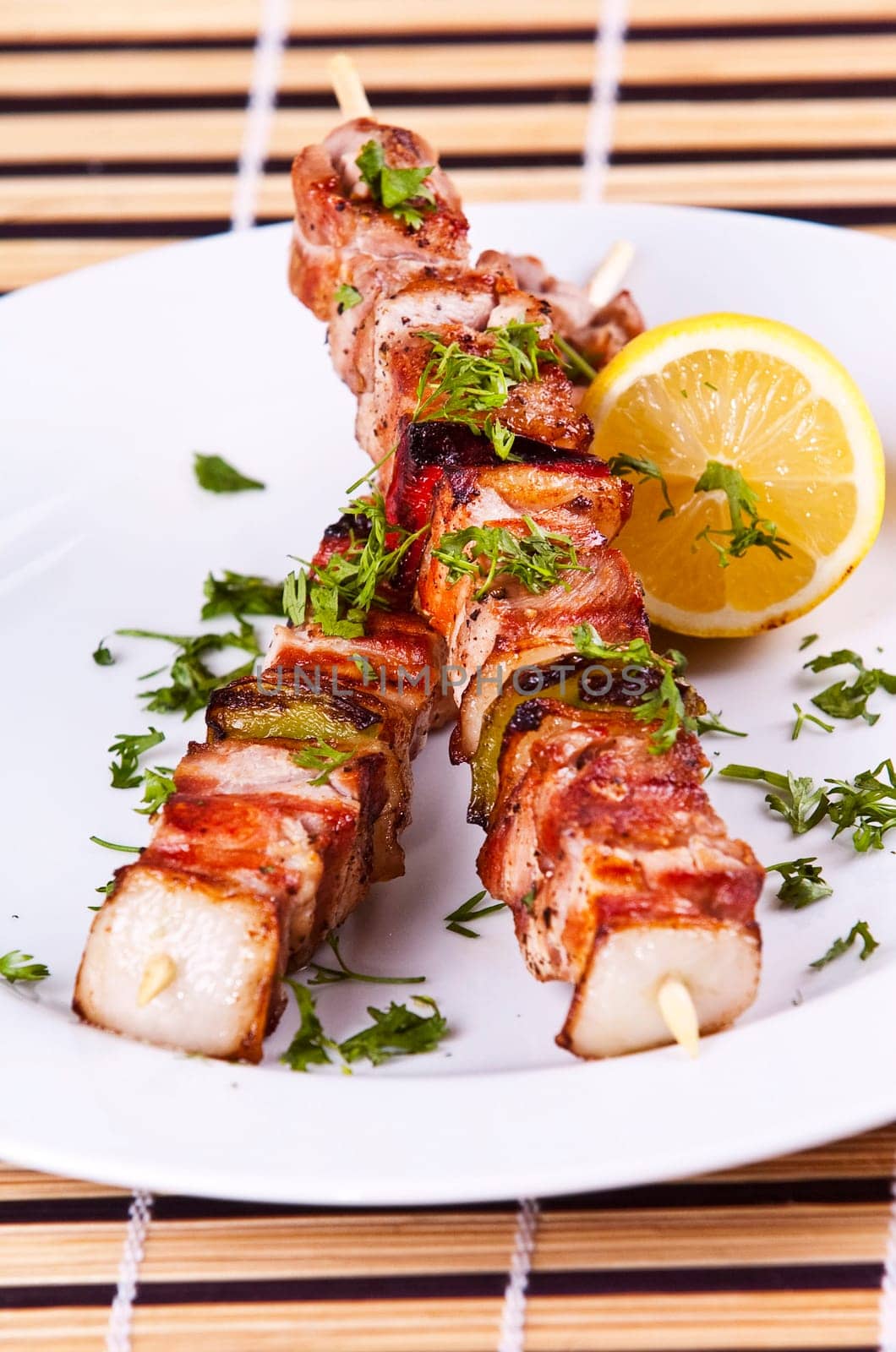 Grilled chicken kebab served a white plate