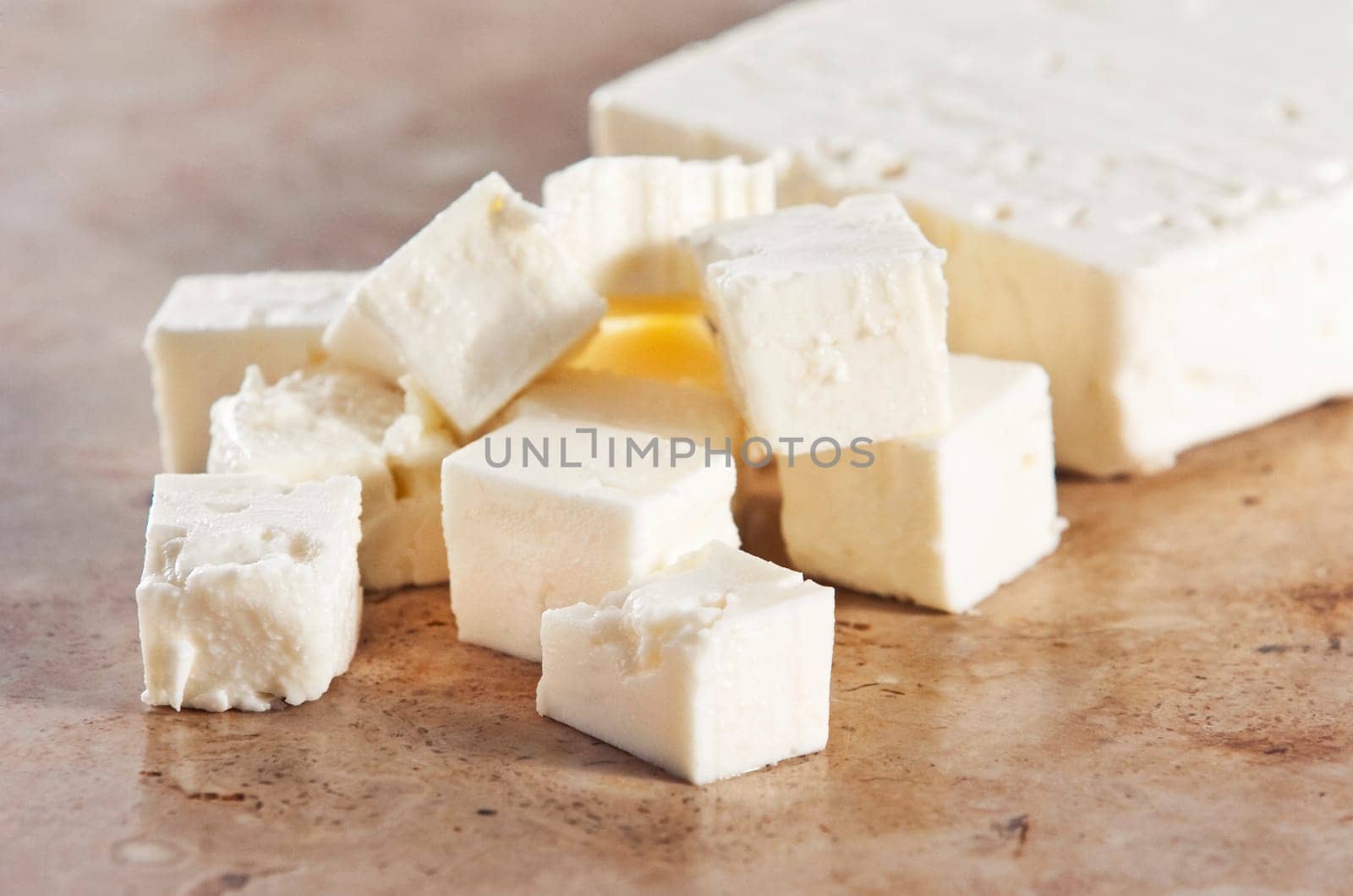 Cubed feta cheese on a kitchen counter