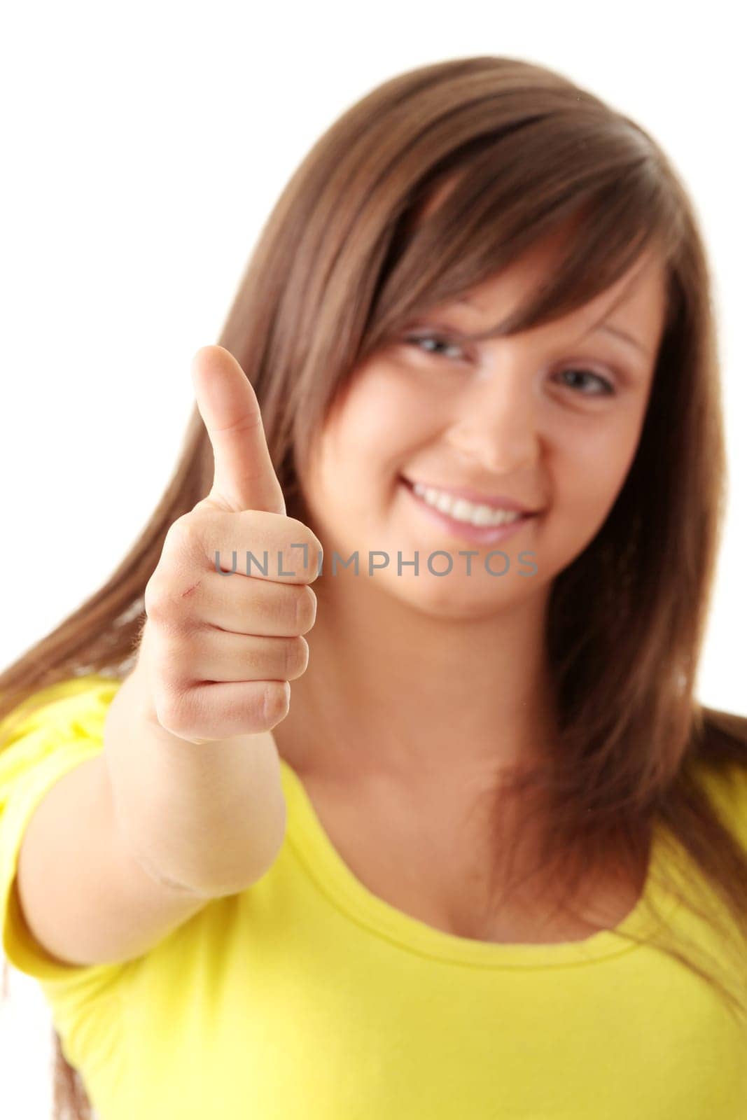 Portrait of lovely teenage girl with thumbs up