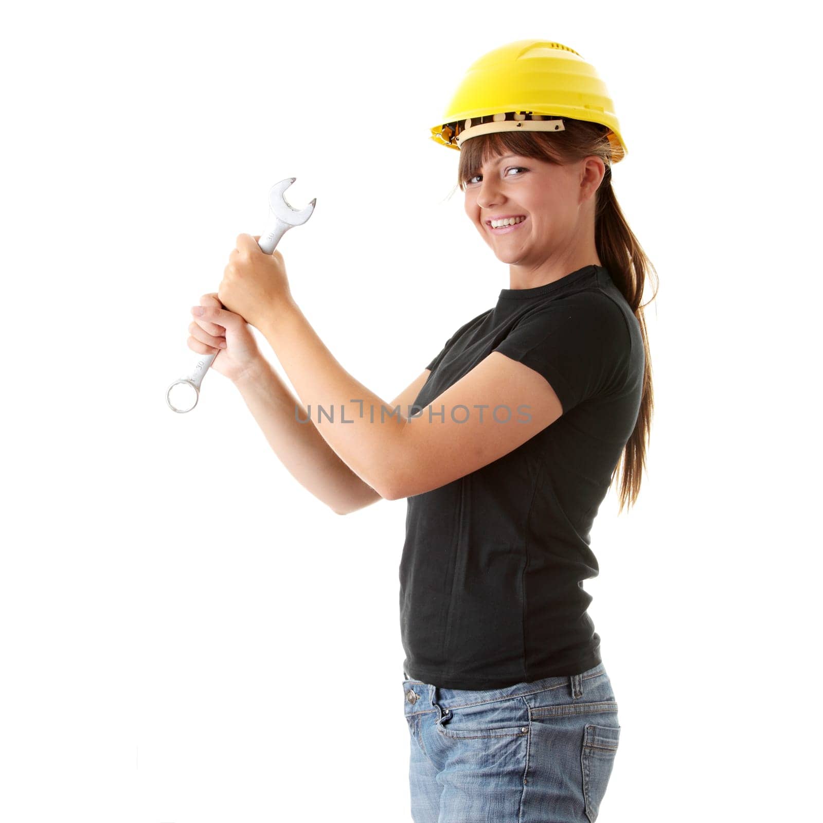 Young woman builder at work with big french key, isolated on white