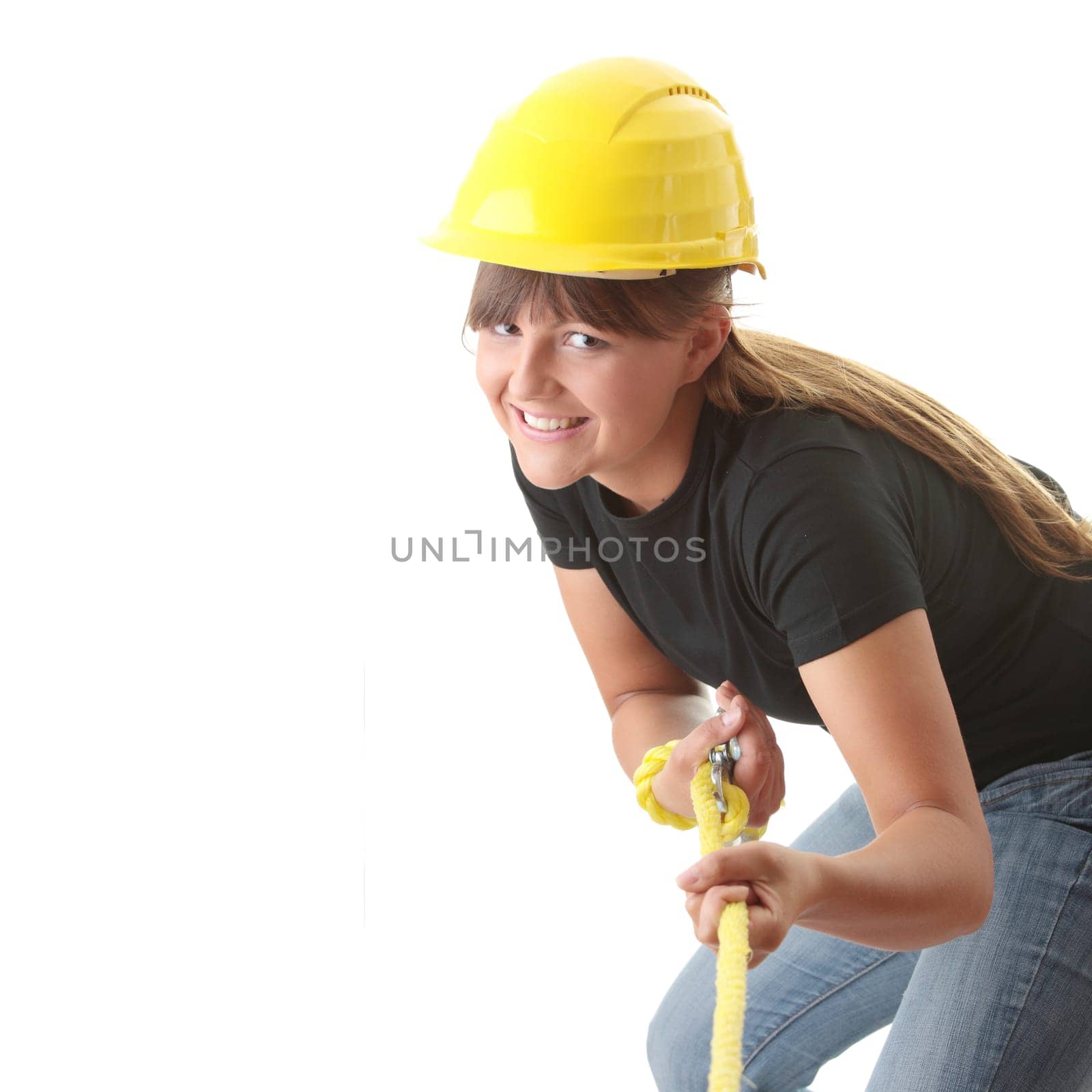 Young woman builder holding yellow rope