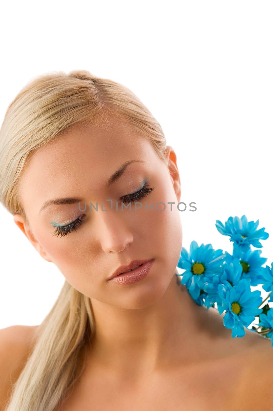 pretty blond girl in a beauty portrait with blue daisy on her shoulder.