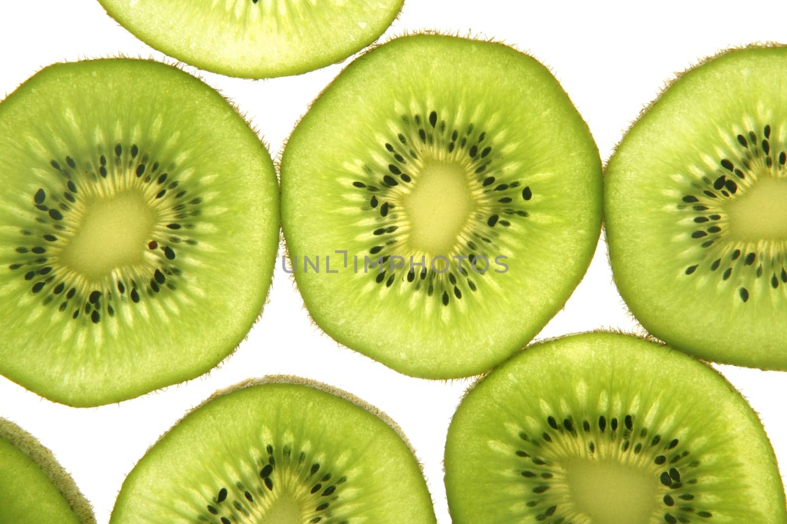 Kiwi green transparent slices over white background