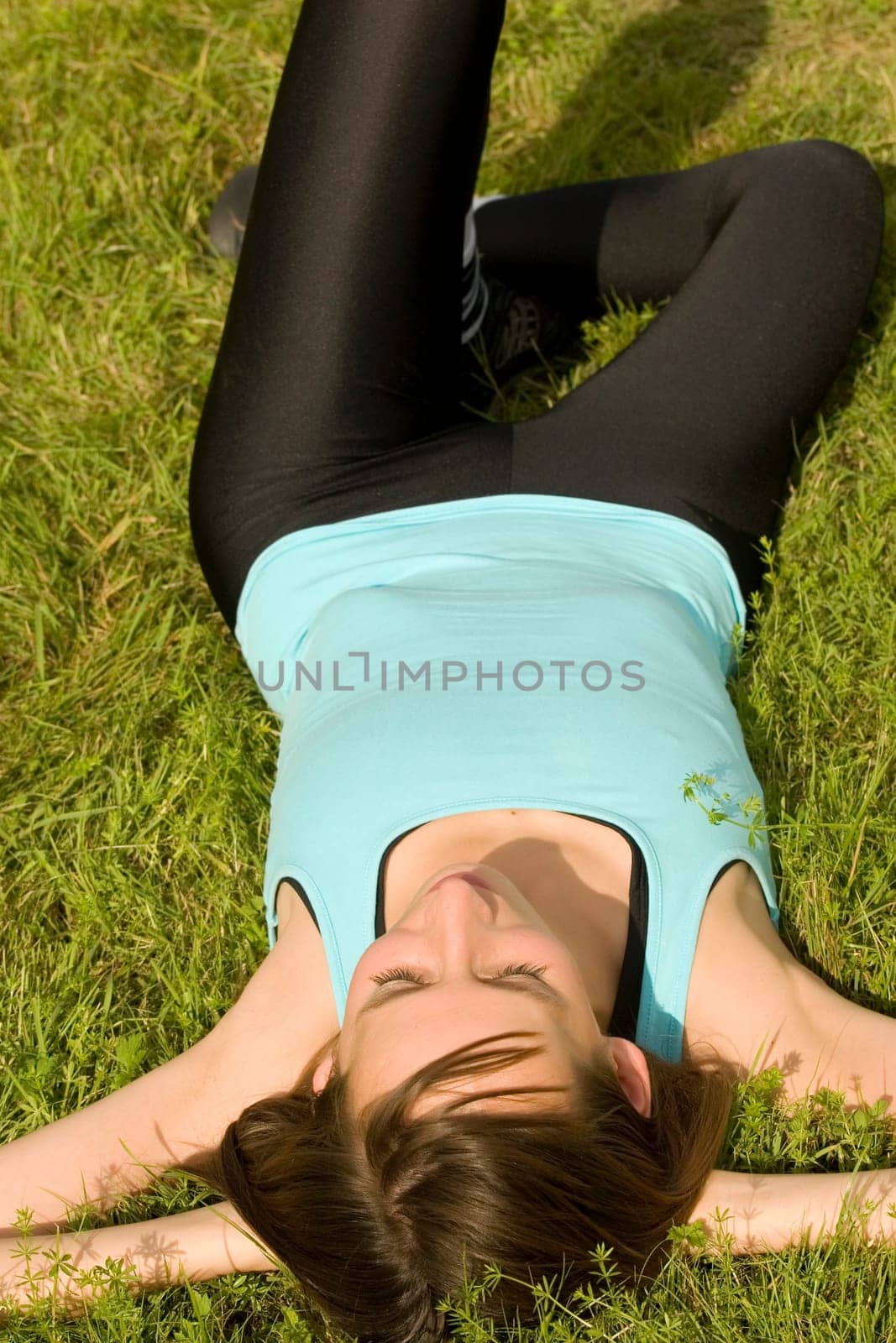 woman relaxing on grass and enjoying the sun