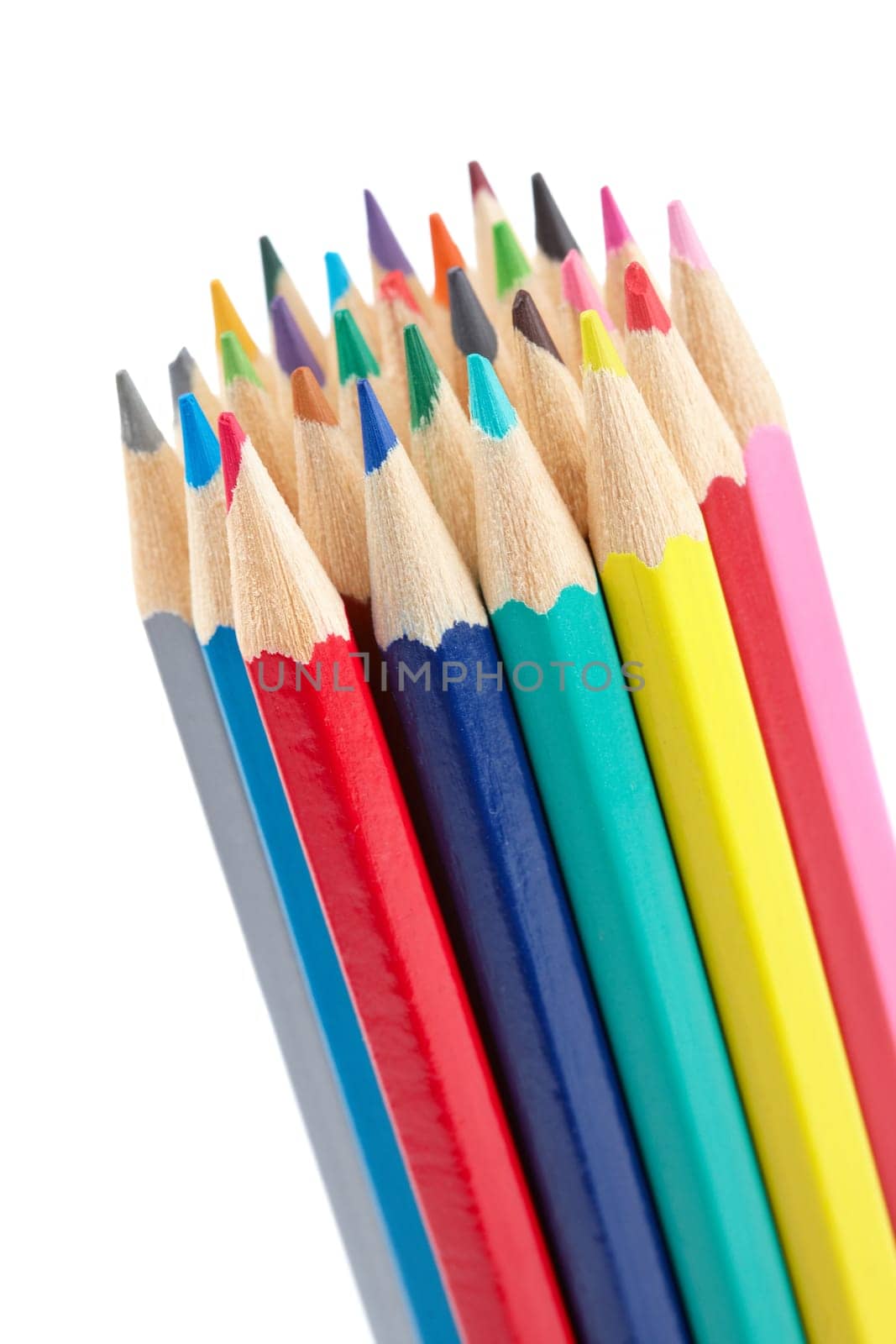 Assortment of coloured pencils isolated on white background. Shallow depth of field