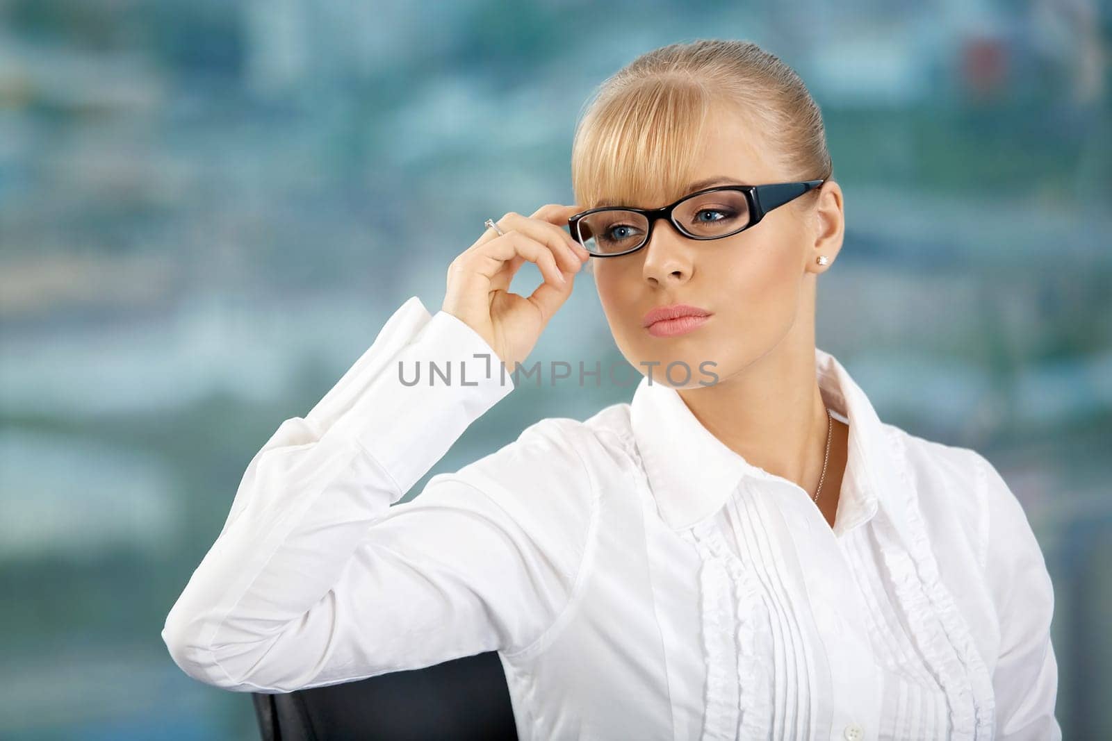 Portrait of the attractive business woman in glasses