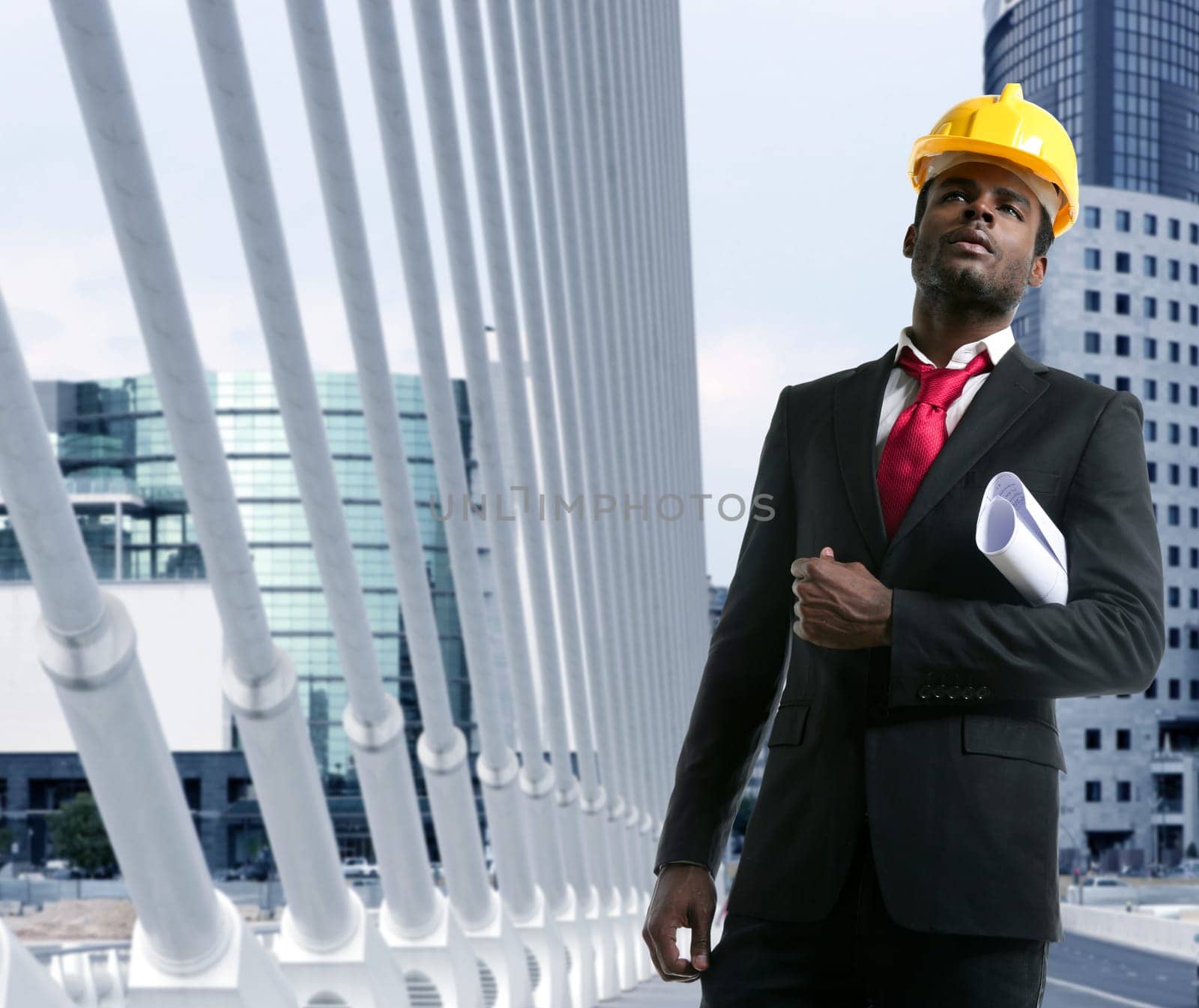 African american architect engineer with yellow hardhat and plans