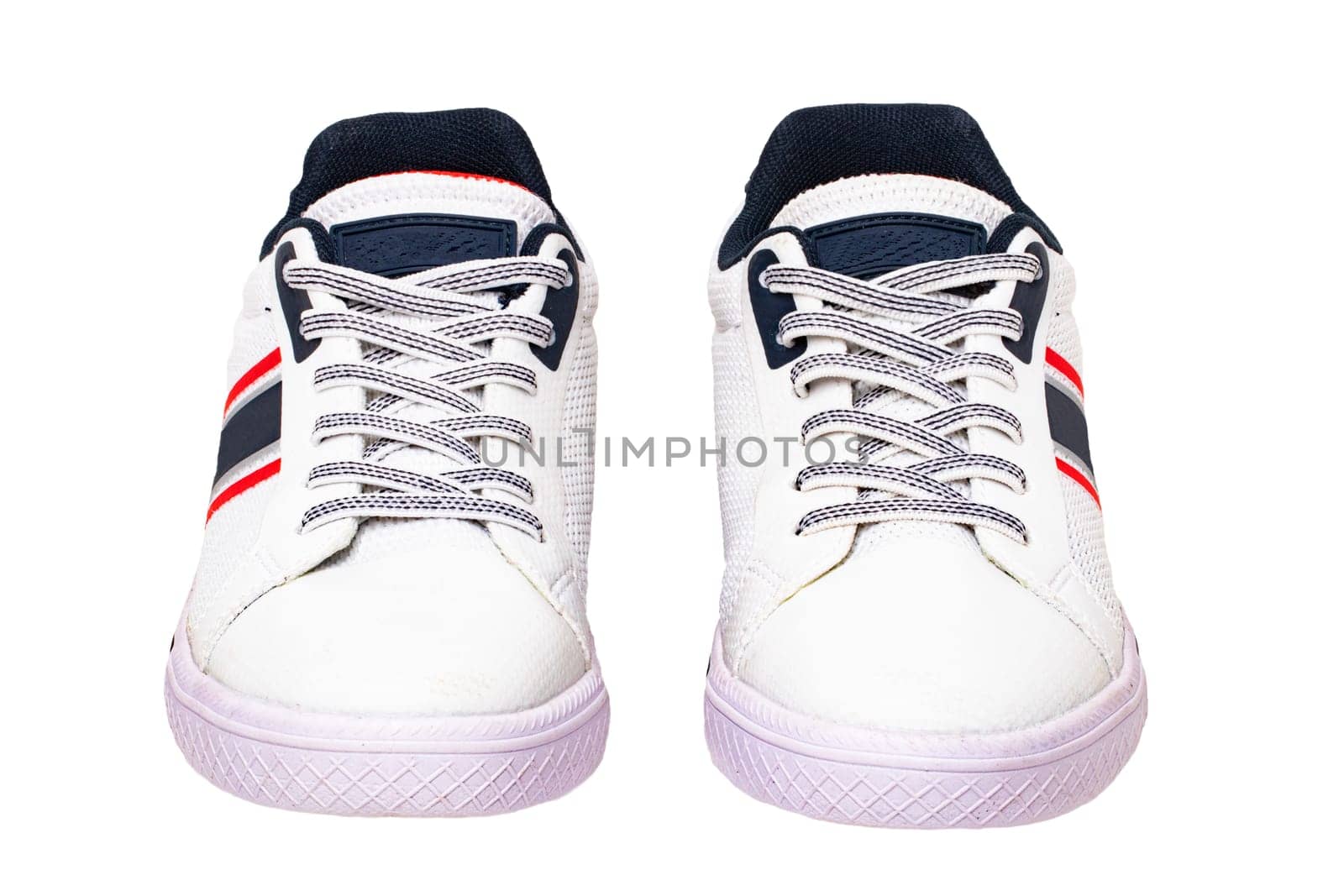 White sneakers isolated. Close-up of a pair white elegant stylish leather sport shoes isolated on a white background. Clipping path. Kids shoe fashion. Modern design footwear for workout. Macro.