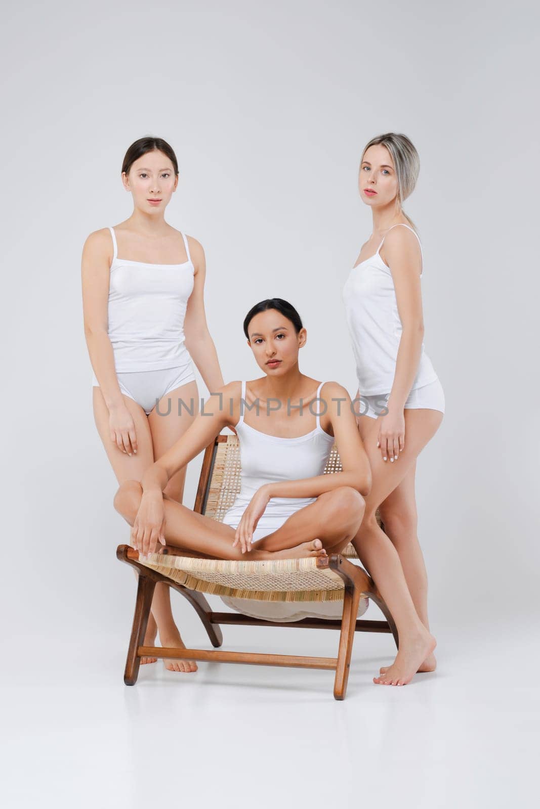 Multi-ethnic beauty concept. Pretty asian, caucasian and african young women posing.