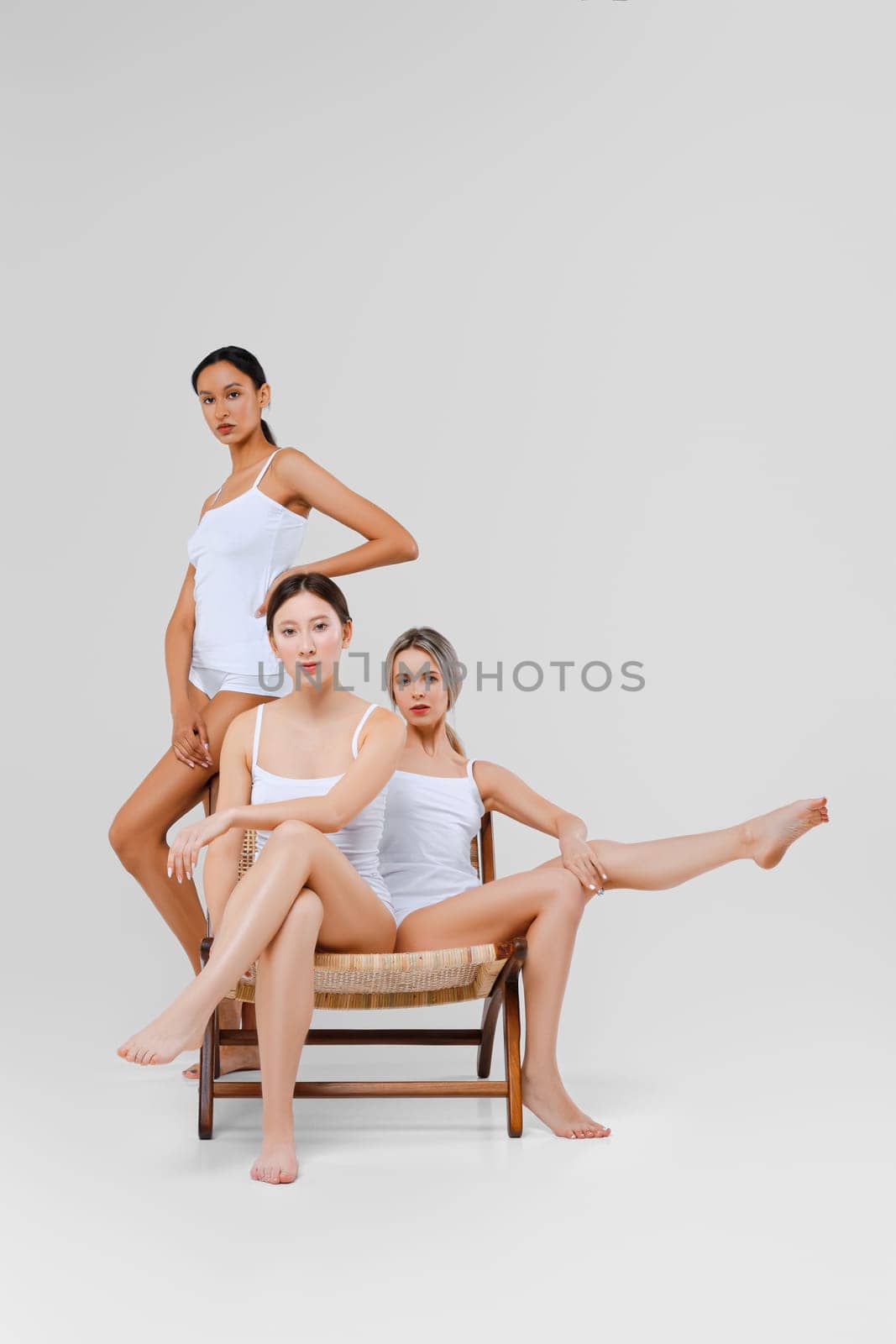 Multi-ethnic beauty concept. Pretty asian, caucasian and african young women posing.