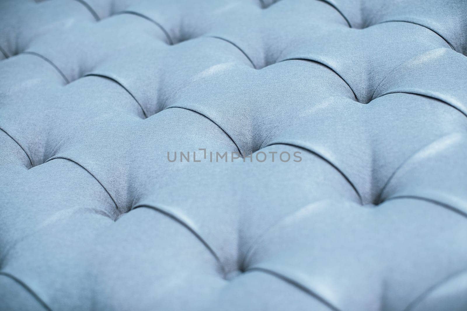 Blue gray upholstered furniture from ement quilted fabric texture. Interior design, headboards made of furniture fabric upholstery. Classic checkered pattern background for furniture, wall, headboard