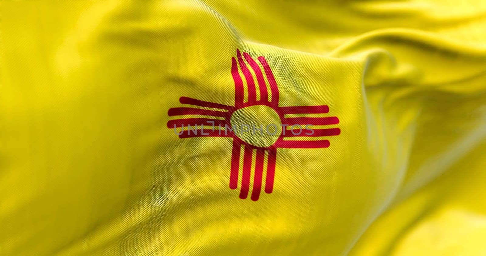 Flag of New Mexico state waving in the wind. New Mexico is a federated state in the southwestern United States. Fabric textured background. Selective focus. 3D illustration